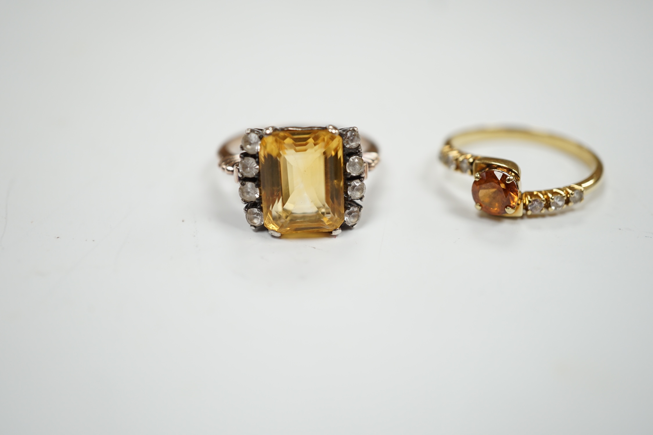 Two yellow metal citrine and simulated diamond set rings, gross weight 7.4 grams.